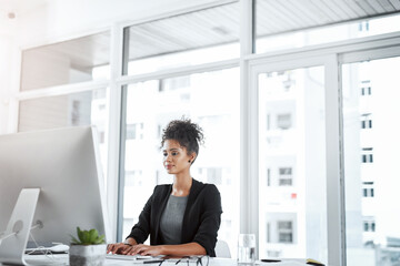 Wall Mural - Typing, smile and woman in office, desk and reading of research for story and creative with inspiration. Happy, online and journalist of news, brainstorming and professional for article in agency