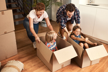 Wall Mural - New house, happy family and children or playing in boxes for real estate, property milestone or celebration for moving day. Love, kids and cardboard package with mortgage investment or home success