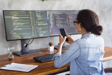 Photo of young girl professional hacker use smart phone loft interior modern office indoors