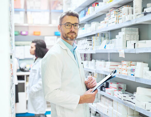 Wall Mural - Pharmacist, portrait and man with clipboard by shelf for inventory, information or medical record. Pharmacy, drugs and mature person with checklist of pills for healthcare, dispensary and storage