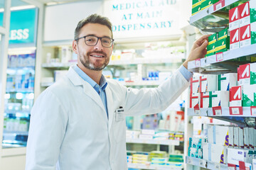 Poster - Pharmacy, pharmacist and portrait of man with pills for wellness, medicine and medical service. Healthcare, pharmaceutical and person in dispensary for medication, supplements and prescription care
