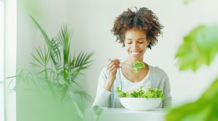 Smiling woman enjoying a green salad in a bright room with natural plants, highlighting a healthy, fresh, and joyful lifestyle.