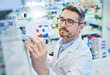 © TamJam/peopleimages.com - Mature man, pharmacist and checking inventory with box for medical supplies, stock or medication at pharmacy. Male person or healthcare employee reading pharmaceuticals or drugs at dispensary store
