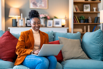 Wall Mural - Smiling young woman business manager discussing ideas over laptop during online meeting at home office.