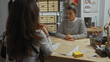 © Krakenimages.com - Two women converse intently in an office with paperwork suggesting law enforcement or detective work.