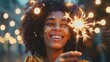 © Tati - Happy woman with curly hair holding sparkler amidst glowing lights