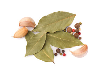 Wall Mural - Aromatic bay leaves, garlic and peppercorns on white background, top view