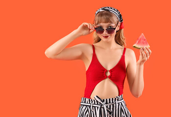 Wall Mural - Young woman with fresh watermelon on red background