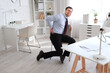 © Pixel-Shot - Young businessman suffering from lumbar pain in office