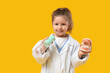 © Pixel-Shot - Cute little dentist with oral irrigator and jaw model on yellow background
