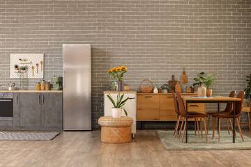 Sticker - Interior of modern comfortable kitchen with fridge, counter and dining table