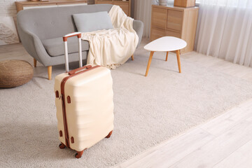 Wall Mural - Packed white suitcase in interior of living room