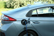 © New Africa - Charging modern electric car from station outdoors