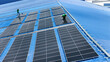 © ultramansk - Worker Technicians are working to construct solar panels system on roof. Installing solar photovoltaic panel system. Men technicians walking on roof structure to check photovoltaic solar modules.