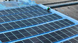 © ultramansk - top aerial of engineer men inspects construction of solar cell panel or photovoltaic cell at roof top. Industrial Renewable energy of green power. factory at urban area. worker working on tower roof.