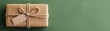 © Chanoknan - Beautifully wrapped gift with a blank tag on green background. Perfect for celebrations, holidays, and special occasions.