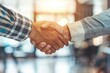 © kitipol - Successful real estate deal with businessmen shaking hands in a bright, modern office setting, signifying partnership and trust