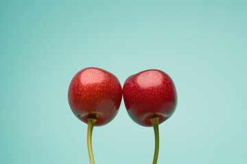 Aufkleber - Symmetrical Abstract Photography of Two Red Cherries Against a Sky Blue Background Captured with a Long Exposure Technique in High Definition