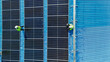 © ultramansk - Worker Technicians are working to construct solar panels system on roof. Installing solar photovoltaic panel system. Men technicians walking on roof structure to check photovoltaic solar modules.
