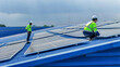 © ultramansk - Worker Technicians are working to construct solar panels system on roof. Installing solar photovoltaic panel system. Men technicians walking on roof structure to check photovoltaic solar modules.