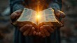 © Игорь Розводовский - hands hold an open Bible, the sun's rays fall on the Bible.