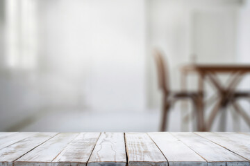 Poster - Empty white wooden table top with blurred background of dining room, ideal for product placement