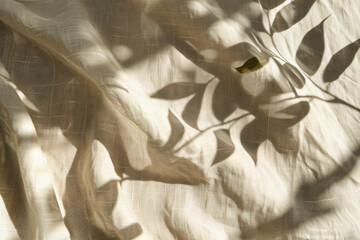 Poster - Photo of a shadow cast on beige linen fabric in the style of leaves, close-up shot. Web banner with empty space on the right.