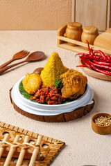 Wall Mural - Tumpeng is an Indonesian cone-shaped rice dish with side dishes of vegetables and meat originating from Javanese cuisine of Indonesia.