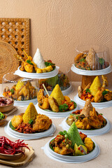 Wall Mural - Tumpeng is an Indonesian cone-shaped rice dish with side dishes of vegetables and meat originating from Javanese cuisine of Indonesia.