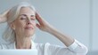 © StudioX180 - Side view of a mid-aged woman stretching and doing desk yoga exercises for relaxation at her office desk, calming workspace.