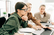 © Ilona - Three business women work in the office. Colleagues are working on a project using computers.