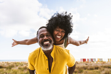beautiful mature senior black couple of lovers dating at the seaside - married african middle-aged c