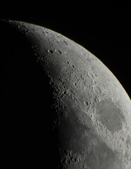 Wall Mural - half moon closeup with moon craters on a dark space background high definition