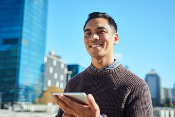 Urban Entrepreneur Smiling Outdoors with Digital Tablet in Hand in City Setting