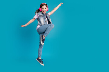 Sticker - Full length photo of adorable small girl headphones dancing listen music dressed stylish denim garment isolated on blue color background