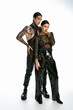 © LIGHTFIELD STUDIOS - A young stylish couple with tattoos standing close together in a studio on a grey background.