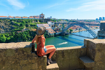 Traveler woman enjoying view of famous bridge in Porto city- Portugal, Europa