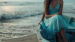© Fotograf - A woman wearing a blue dress is seated in a small boat