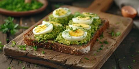 Poster - A wooden cutting board serving as a base for breakfast or brunch, featuring sliced eggs and creamy avocado