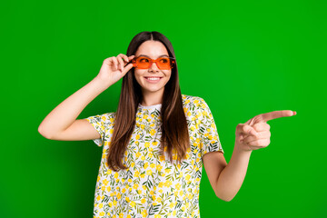 Poster - Photo portrait of pretty teen girl sunglass point look empty space wear trendy flowers print outfit isolated on green color background