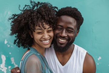 Wall Mural - Portrait of a joyful multicultural couple in their 30s dressed in a breathable mesh vest in front of pastel teal background