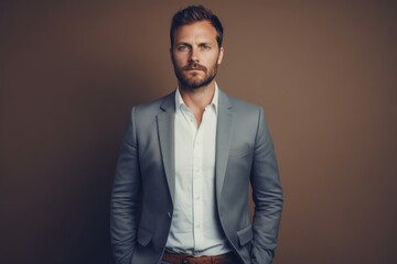 Wall Mural - Portrait of a content man in his 40s dressed in a stylish blazer in front of light wood minimalistic setup