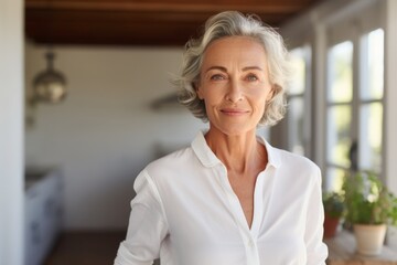 Sticker - Portrait of a blissful woman in her 60s wearing a simple cotton shirt while standing against stylized simple home office background