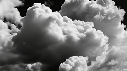 puffy cloud formations set against a black screen for dramatic effect