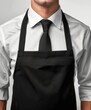 © Stone Story - Professional waiter wearing a black apron and tie over a white shirt, ready to serve in a restaurant setting.