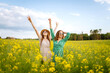 © maxbelchenko - Attractive two woman in the blooming field. Nature, vacation, relax and lifestyle. Summer landscape.
