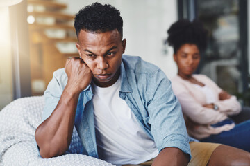 Canvas Print - Angry, man and couple with conflict on sofa for cheating, betrayal and affair with ignore or breakup in home. Black people, frustrated and toxic marriage in living room with disagreement and argument