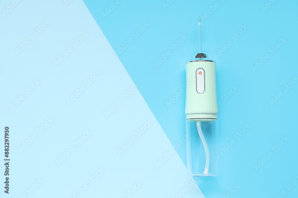 Oral irrigator on blue background