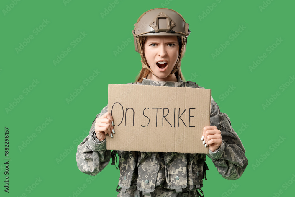Protesting female soldier holding placard with text ON STRIKE against green background