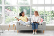 © Pixel-Shot - African-American girl talking to psychologist on sofa in office
